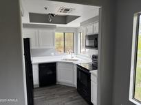 Well lit kitchen featuring white cabinets, modern appliances, stylish countertops, and neutral colors at 7008 E Gold Dust Ave # 234, Paradise Valley, AZ 85253