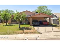 Charming single-story home featuring a covered carport and a well-maintained fenced yard at 2513 E Randall Dr, Tempe, AZ 85288