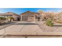 Single-story home featuring a well-maintained front yard and a spacious two-car garage at 2738 E Silversmith Trl, San Tan Valley, AZ 85143