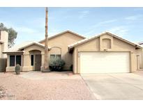 Charming single-story home featuring a two-car garage, desert landscaping, and a well-maintained front yard at 1132 E Harbor View Dr, Gilbert, AZ 85234