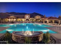 Resort-style community pool with stunning mountain views and a beautiful fountain feature at 2041 N 88Th St, Mesa, AZ 85207