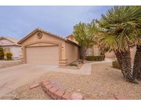 Charming single-story home featuring a two-car garage, neutral stucco and low-maintenance desert landscaping at 20449 N 105Th Ave, Peoria, AZ 85382