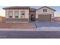 Beautiful single-story home with a brick-accented facade, paver driveway, and a welcoming entrance at 2636 E Virginia St, Mesa, AZ 85213