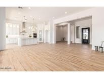 Bright, open-concept living space with wood floors flows seamlessly into a modern kitchen at 2636 E Virginia St, Mesa, AZ 85213