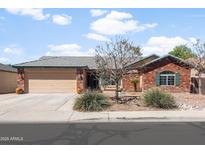 Charming single-story brick home featuring a two-car garage and low-maintenance desert landscaping at 40020 N Cape Wrath Dr Dr, San Tan Valley, AZ 85140