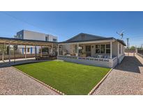 Charming home featuring an inviting front porch and a low-maintenance artificial turf lawn at 4518 N 8Th Pl, Phoenix, AZ 85014