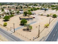 Charming single-story ranch home with a long driveway and desert landscaping in a rural setting at 51089 W Julie Ln, Maricopa, AZ 85139