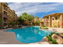 Gorgeous community pool with palm trees and luxury apartment buildings in the background at 5450 E Deer Valley Dr # 3023, Phoenix, AZ 85054
