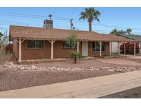 Charming single story brick home with desert landscaping and covered parking area at 8137 E Indianola Ave, Scottsdale, AZ 85251