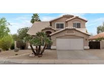 Charming two-story home featuring desert landscaping, a two-car garage and tile roof at 9509 W Tonopah Dr, Peoria, AZ 85382