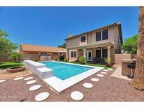 Inviting backyard pool with stepping stones and a patio, perfect for outdoor entertaining and relaxation at 9509 W Tonopah Dr, Peoria, AZ 85382
