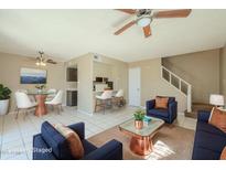 Comfortable living room featuring modern furnishings, cozy seating, and a stylish ceiling fan at 4614 E Pueblo Ave, Phoenix, AZ 85040