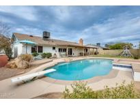 Private backyard with a refreshing pool, a diving board, and ample space for outdoor entertaining at 3149 W Danbury Dr, Phoenix, AZ 85053