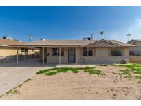Charming single-story home featuring a covered carport and a low-maintenance front yard at 339 E 9Th Dr, Mesa, AZ 85210
