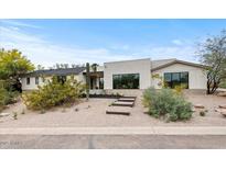Stylish single-story home featuring a desert landscaped front yard and large windows for ample natural light at 4035 E Mcdonald Dr, Phoenix, AZ 85018
