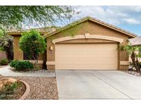 Charming single-story home featuring a two-car garage, desert landscaping, and a neutral color palette at 4140 E Sundance Ave, Gilbert, AZ 85297
