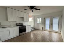 Modern kitchen featuring white cabinets, stainless steel appliances, and wood-look floors at 8125 E 5Th Ave, Mesa, AZ 85208