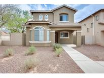Inviting two-story home featuring a desert-landscaped front yard and covered entryway at 9435 S 33Rd Dr, Laveen, AZ 85339