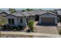 Charming single-story home with a beautiful tile roof, landscaping, and brick driveway at 9903 E Rotation Dr, Mesa, AZ 85212