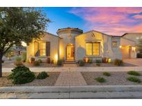 Charming front elevation featuring manicured landscaping, a decorative gate, and warm lighting at 10510 E Sanger Ave, Mesa, AZ 85212