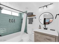Charming bathroom with updated vanity, modern fixtures, and tiled shower/tub, offering a refreshing and functional space at 413 E Linda Ln # D, Gilbert, AZ 85234