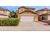 Two-story home featuring a white garage door and neutral color scheme, complemented by a well-maintained lawn at 1096 E Rolls E Rd, San Tan Valley, AZ 85143