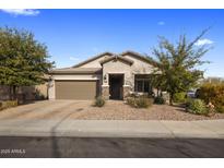 Charming single-story home featuring a well-maintained landscaped front yard, a two car garage and stone accents at 11148 E Tumbleweed Ave, Mesa, AZ 85212