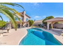 Inviting backyard pool with desert landscaping and a covered patio, perfect for outdoor entertaining at 1313 W Glenmere Dr, Chandler, AZ 85224