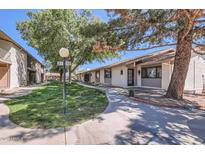 Charming single-story home with well-maintained landscaping and a welcoming walkway at 1550 N Stapley Dr # 21, Mesa, AZ 85203