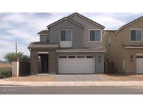 Charming two-story home with a two-car garage and well-maintained landscaping at 1571 E Tiffany Way, Gilbert, AZ 85298