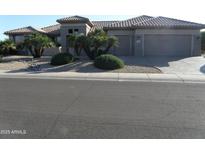 Charming single-story home featuring a two-car garage and desert landscaping at 18001 N Timber Ridge Dr, Surprise, AZ 85374