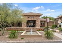 Elegant clubhouse entrance with stone accents, fountain and manicured landscaping, plus visible fire lane at 20100 N 78Th Pl # 2203, Scottsdale, AZ 85255