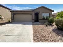 Charming single-story home featuring a two-car garage and low-maintenance desert landscaping at 2367 E Rosario Mission Dr, Casa Grande, AZ 85194