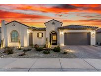 Charming single-story home with landscaped front yard and desert landscaping under a colorful dusk sky at 26999 W Ponderosa Ln, Buckeye, AZ 85396