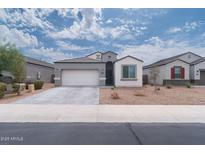 Charming single-story home featuring a two-car garage and low-maintenance desert landscaping at 31045 W Mulberry Dr, Buckeye, AZ 85396