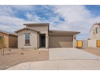 Charming single-story home with a well-maintained desert landscape and a two-car garage at 39960 W Bunker Dr, Maricopa, AZ 85138