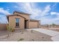 Charming single-story home featuring neutral stucco, a two-car garage, and low-maintenance desert landscaping at 40025 W Bunker Dr, Maricopa, AZ 85138
