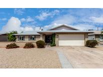 Charming single-story brick home featuring a well-manicured front yard and attached two-car garage at 4138 W Barbara Ave, Phoenix, AZ 85051