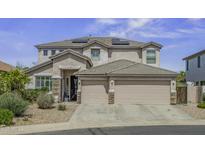 Stunning two-story home featuring a three car garage, neutral paint and solar panels at 43650 W Snow Dr, Maricopa, AZ 85138