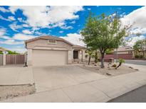 Charming single-story home with a well-maintained yard and two car garage at 10064 E Kilarea Ave, Mesa, AZ 85209