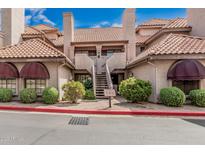 Charming two-story condo with desert landscaping, red tile roof, and neutral-colored stucco at 1211 N Miller Rd # 213, Scottsdale, AZ 85257