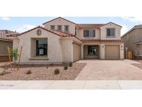 Charming two-story home featuring a terracotta roof, three-car garage, and well-maintained landscaping at 17643 W Rancho Dr, Litchfield Park, AZ 85340