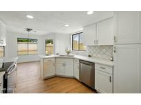 Bright kitchen featuring white cabinets, stainless appliances, and views to backyard at 1918 E Anchor Dr, Gilbert, AZ 85234