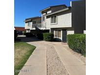 Inviting two-story townhome with a well-maintained landscape and a private walkway at 19601 N 7Th N St # 1032, Phoenix, AZ 85024