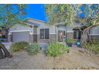 Charming single-story home with beautiful landscaping and a welcoming front entrance at 27173 N 86Th Ave, Peoria, AZ 85383