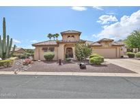 Charming single-story home featuring desert landscaping, a tiled roof, and an attached two car garage at 2862 N 156Th Dr, Goodyear, AZ 85395