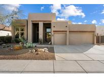 Charming single-story home featuring a landscaped front yard and a two-car garage with wooden beam accents at 4817 E Cielo Grande Ave, Phoenix, AZ 85054
