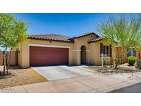 Charming single-story home featuring a tile roof, two-car garage, and inviting front yard landscaping at 6413 S 47Th Dr, Laveen, AZ 85339