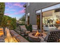 Outdoor patio with a water feature, fire pit, and seating, perfect for enjoying evenings at 6929 E Montreal Pl, Scottsdale, AZ 85254