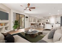 Bright living room featuring a ceiling fan, modern furniture and an open concept layout with views of the kitchen at 705 W Queen Creek Rd # 2078, Chandler, AZ 85248